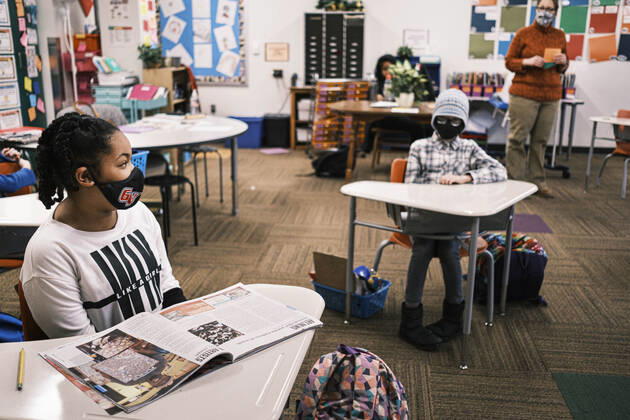 February 17, 2021, Des Moines, Iowa, U.S: Socially distanced 4th grade students at Walnut Street School in downtown Des Moines. Des Moines Public Schools (DMPS) opened to in person education this week after teaching most of the 2020-2021 school year either remotely or with a hybrid remote learning model. Elementary school classrooms, which used to sit 2-4 students at a table, have gone to individual desks, placed 6 feet apart, in classrooms. Students are required to wear masks for most class activities. The district has ended its hybrid model. The Governor of Iowa has aggressively pushed schools to return to in person education, going so far as to threaten to withhold funds from districts that don t return to in person classes. DMPS, the la - ZUMAk94_ 20210217_zaf_k94_013 Copyright: xJackxKurtzx