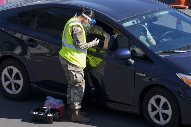 February 17, 2021, Los Angeles, California, USA: A passenger receives a COVID-19 vaccine from a member of the National Guard at a joint state and federal COVID-19 vaccination site on the campus of California State University of Los Angeles in Los Angeles, Wednesday, Feb. 17, 2021. Los Angeles USA - ZUMAc68_ 20210217_zaf_c68_014 Copyright: xRingoxChiux