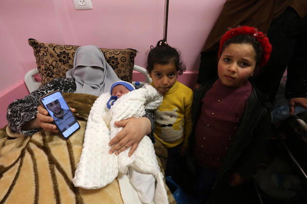 February 18, 2021, khan Younis, Gaza Strip, Palestinian Territory: The wife of the Palestinian prisoner Mohammad al-Qudra, holds her newborn baby, from whom she conceived with sperm smuggled out of an Israeli prison, at Nasser Medical Complex in khan Younis in the southern of Gaza strip on February 18, 2021. Since 2004, Palestinian security prisoners, who are denied conjugal visitations by their wives, have tried to smuggle their sperm out of Israeli prisons, so that their wives can be inseminated in fertility clinics in the West Bank and Ghazza, and bear them children khan Younis Palestinian Territory - ZUMAap3_ 20210218_zaf_ap3_175 Copyright: xAshrafxAmrax