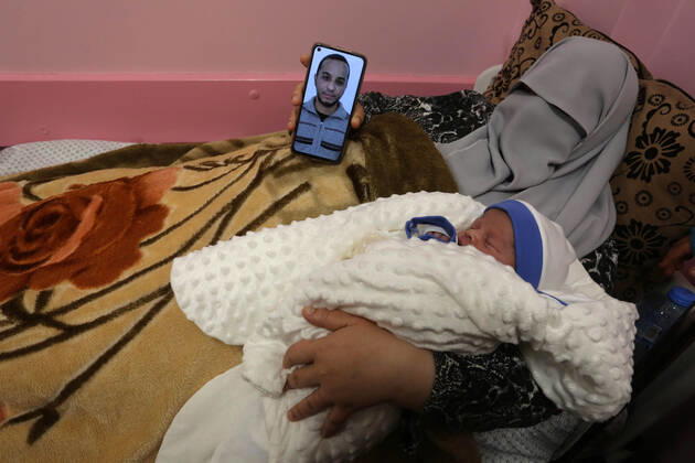 February 18, 2021, khan Younis, Gaza Strip, Palestinian Territory: The wife of the Palestinian prisoner Mohammad al-Qudra, holds her newborn baby, from whom she conceived with sperm smuggled out of an Israeli prison, at Nasser Medical Complex in khan Younis in the southern of Gaza strip on February 18, 2021. Since 2004, Palestinian security prisoners, who are denied conjugal visitations by their wives, have tried to smuggle their sperm out of Israeli prisons, so that their wives can be inseminated in fertility clinics in the West Bank and Ghazza, and bear them children khan Younis Palestinian Territory - ZUMAap3_ 20210218_zaf_ap3_193 Copyright: xAshrafxAmrax