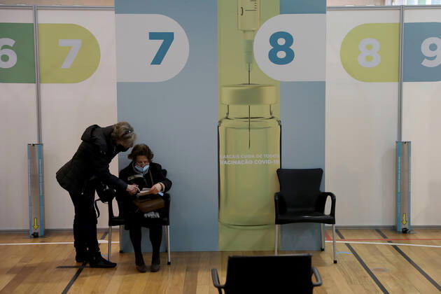 February 18, 2021, Lisbon, Portugal: People wait in front of vaccination booths to be inoculated with the Pfizer-BioNTech Covid-19 vaccine at Sao Domingos de Rana sports complex, in Cascais, Portugal, on February 18, 2021. Portugal continues with the first phase of inoculation against COVID-19 for citizens over 80 or belonging to risk groups as the number of new officially confirmed COVID-19 cases has been falling since the end of January. Lisbon Portugal - ZUMAf123 20210218_zap_f123_003 Copyright: xPedroxFiuzax