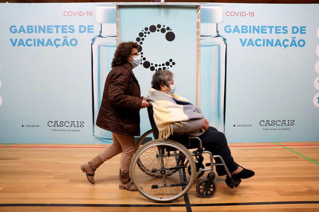 February 18, 2021, Lisbon, Portugal: People walk past vaccination booths after been inoculated with the Pfizer-BioNTech Covid-19 vaccine at Sao Domingos de Rana sports complex, in Cascais, Portugal, on February 18, 2021. Portugal continues with the first phase of inoculation against COVID-19 for citizens over 80 or belonging to risk groups as the number of new officially confirmed COVID-19 cases has been falling since the end of January. Lisbon Portugal - ZUMAf123 20210218_zap_f123_015 Copyright: xPedroxFiuzax