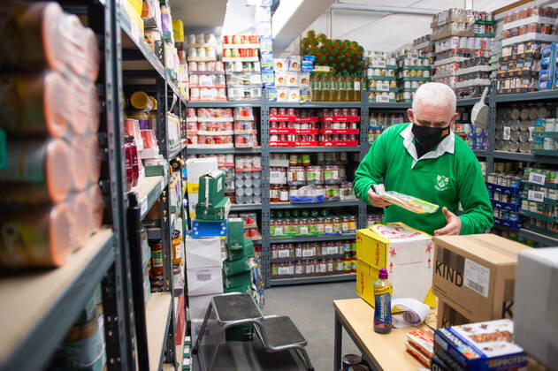 A volunteer helps pack food at the FC United Foodhub for distribution amongst residents and vulnerable groups affected by the Coronavirus pandemic, on 19 February 2021. The food bank is situated at Broadhurst Park, home of non-league football team FC United of Manchester. Broadhurst Park is situated in the Moston area of the city, where a new strain of the Coronavirus, E484K, has been detected in the community over the past few days. The club has been shortlisted in the Football SupportersÕ Association Lockdown Heroes Awards for 2020. Moston Greater Manchester England Broadhurst Park  Copyright: xMattxWilkinsonx