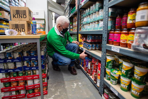 A volunteer helps pack food at the FC United Foodhub for distribution amongst residents and vulnerable groups affected by the Coronavirus pandemic, on 19 February 2021. The food bank is situated at Broadhurst Park, home of non-league football team FC United of Manchester. Broadhurst Park is situated in the Moston area of the city, where a new strain of the Coronavirus, E484K, has been detected in the community over the past few days. The club has been shortlisted in the Football SupportersÕ Association Lockdown Heroes Awards for 2020. Moston Greater Manchester England Broadhurst Park  Copyright: xMattxWilkinsonx