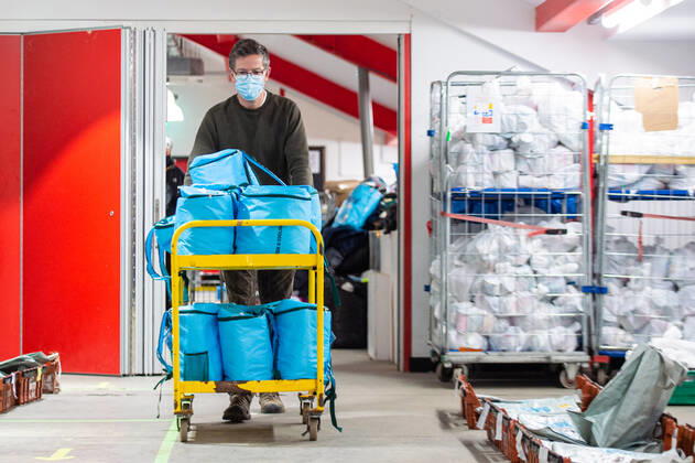 A volunteer helps pack food at the FC United Foodhub for distribution amongst residents and vulnerable groups affected by the Coronavirus pandemic, on 19 February 2021. The food bank is situated at Broadhurst Park, home of non-league football team FC United of Manchester. Broadhurst Park is situated in the Moston area of the city, where a new strain of the Coronavirus, E484K, has been detected in the community over the past few days. The club has been shortlisted in the Football SupportersÕ Association Lockdown Heroes Awards for 2020. Moston Greater Manchester England Broadhurst Park  Copyright: xMattxWilkinsonx