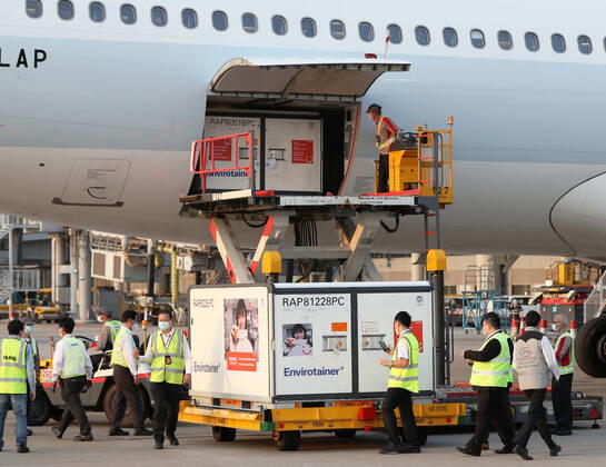(210219) -- HONG KONG, Feb. 19, 2021 -- Staff members transport the vaccines at the Hong Kong International Airport in Hong Kong, south China, Feb. 19, 2021. The first batch of mainland-manufactured COVID-19 vaccines arrived in Hong Kong on Friday afternoon, which, as the first vaccines available here, will enable the financial hub to start inoculating its residents next week. ) CHINA-HONG KONG-COVID-19-VACCINE-ARRIVAL (CN) LixGang 