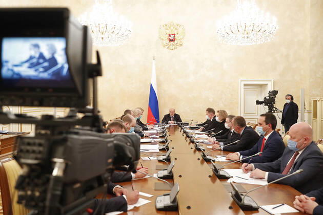 MOSCOW, RUSSIA - FEBRUARY 20, 2021: Russia s Prime Minister Mikhail Mishustin (C) during a meeting on circulation of vaccines at the House of the Russian Government. Dmitry Astakhov POOL TASS  TS0F748D