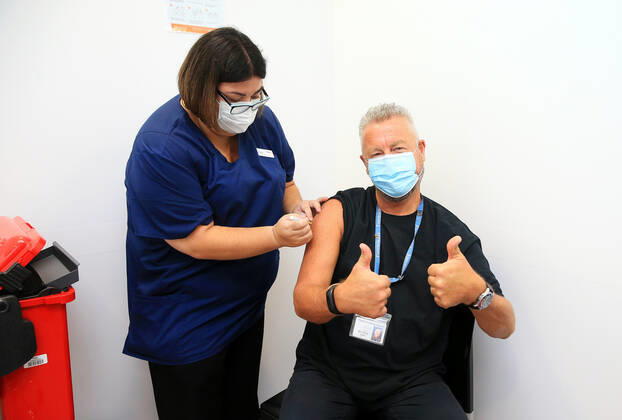 VIC COVID19 VACCINE ROLLOUT, Dr Chris Quinn, who has been working in hotel quarantine receives one of the first Pfizer coronavirus vaccines by nurse Jessica Amalfi at Austin Health in Melbourne, Monday, February 22, 2021. Australia will begin its roll out of the Pfizer coronavirus vaccine on Monday, the country s most complicated logistical exercise to date. ( NO ARCHIVING, EDITORIAL USE ONLY, NO USE IN BOOKS WITHOUT CONSENT MELBOURNE VIC AUSTRALIA  Copyright: xMARKxSTEWARTx 20210222001522293641