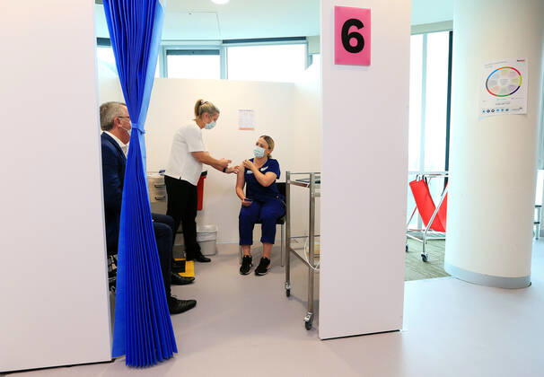 VIC COVID19 VACCINE ROLLOUT, Covid screening nurse Grace Gibney receives one of the first Pfizer coronavirus vaccines from Nurse practitioner Sonja Elia at Austin Health in Melbourne, Monday, February 22, 2021. Australia will begin its roll out of the Pfizer coronavirus vaccine on Monday, the country s most complicated logistical exercise to date. ( NO ARCHIVING, EDITORIAL USE ONLY, NO USE IN BOOKS WITHOUT CONSENT MELBOURNE VIC AUSTRALIA Copyright: xMARKxSTEWARTx 20210222001522293672
