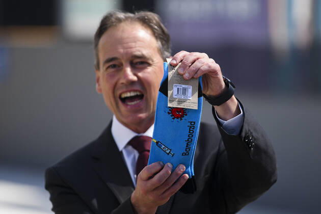 ACT COVID19 VACCINE ROLLOUT, Australian Health Minister Greg Hunt holds up a pair of socks depicting a syringe and a virus after the start of the Biotech Pfizer COVID-19 vaccine rollout at the COVID-19 surge centre in Canberra, Monday, February 22, 2021. Australia will begin its roll out of the Pfizer coronavirus vaccine on Monday, the country s most complicated logistical exercise to date. ( NO ARCHIVING, EDITORIAL USE ONLY, NO USE IN BOOKS WITHOUT CONSENT CANBERRA ACT AUSTRALIA  Copyright: xLUKASxCOCHx 20210222001522295717
