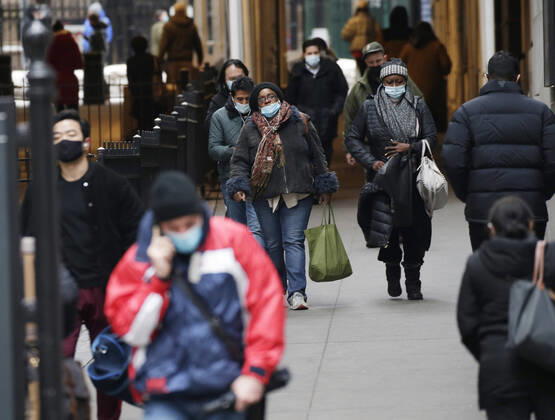 Pedestrian walk wearing face masks to protect from and to prevent the spread of the coronavirus on Wall Street in New York City on Monday February 22, 2021. COVID-19 deaths have now surpassed the 500,000 mark in the United States.  NYP20210222110 JohnxAngelillo