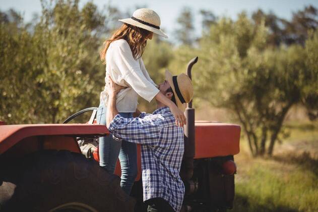 Young couple looking at each other while standing by tractor Young couple looking at each other while standing by tractor at olive farm, model released, , property released, Cape Town, South Africa, 22.03.2017, 1008932.jpg, couple, looking, standing, tractor, olive farm, farm, lifestyle, leisure, casual, white, checked pattern, girlfriend, boyfriend, sun hat, protection, safety, holding, heterosexual couple, together, bonding, love, tree, nature, joy, fun, sunlight, land vehicle, agricultural machinery 30s, Mid Adult, Woman, Female, Hispanic, 20s, Young Adult, Man, Male, Caucasian, 30-34 Years, Mid Adult Women, Hispanic Ethnicity, 25-29 Years, Young Men, Caucasian Ethnicity Outdoors,Side view,Focus on Foreground,Day