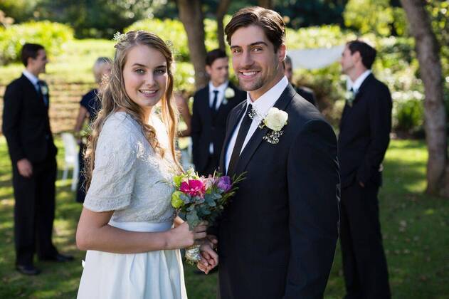 Happy bride and groom standing in park Portrait of happy bride and groom standing in park, model released, , property released, Cape Town, South Africa, 2017-05-01T23:00:00.000Z, 1050866.jpg, sunny, summertime, park, courtyard, wedding, marriage, life event, ceremony, celebration, event, elegance, fashion, fashionable, modern, bride, groom, wedding dress, full suit, standing, smiling, happy, cheerful, bouquet, flower, holding, reception, together, stylish, attractive, beginnings, lifestyle, handsome, smart, beautiful, love, affection, closeness, fondness, bonding, luxury, newly married, just married, confidence, couple, relationship 50s, Mature Adult, Woman, Female, Caucasian, 30s, Mid Adult, Man, Male, 20s, Young Adult, 50-54 Years, Matur