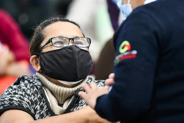 (210223) -- ECATEPEC, Feb. 23, 2021 -- A medical worker inoculates a citizen with a COVID-19 vaccine developed by Chinese pharmaceutical company Sinovac at a vaccination site in Ecatepec, Mexico, Feb. 22, 2021. Mexican health authorities on Monday began to vaccinate older adults with a COVID-19 vaccine developed by Chinese pharmaceutical company Sinovac, after a shipment of doses arrived on Saturday. Mexico s government designated the first shipment of the Sinovac vaccine to arrive in Ecatepec, a city in central State of Mexico that lies on the outskirts of the capital Mexico City. Early in the day, brigades of healthcare workers began to administer the vaccine to hundreds of residents aged 60 and over who went to the Las Americas 