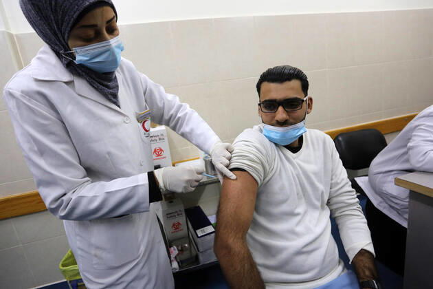 February 23, 2021, Khan Yunis, Gaza Strip, Palestinian Territory: A Palestinian health worker administers a dose of the Russian Sputnik V coronavirus vaccine to a man, at European Hospital, in Khan Yunis, in the southern Gaza Strip on February 23, 2021. Around 20,000 coronavirus vaccine doses from the UAE arrived in Gaza, a delivery reportedly orchestrated by a rival of Palestinian president Mahmud Abbas three months before scheduled Palestinian elections Khan Yunis Palestinian Territory - ZUMAap3_ 20210223_zaf_ap3_046 Copyright: xAshrafxAmrax