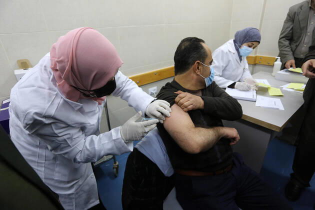 February 23, 2021, Khan Yunis, Gaza Strip, Palestinian Territory: A Palestinian health worker administers a dose of the Russian Sputnik V coronavirus vaccine to a man, at European Hospital, in Khan Yunis, in the southern Gaza Strip on February 23, 2021. Around 20,000 coronavirus vaccine doses from the UAE arrived in Gaza, a delivery reportedly orchestrated by a rival of Palestinian president Mahmud Abbas three months before scheduled Palestinian elections Khan Yunis Palestinian Territory - ZUMAap3_ 20210223_zaf_ap3_054 Copyright: xAshrafxAmrax