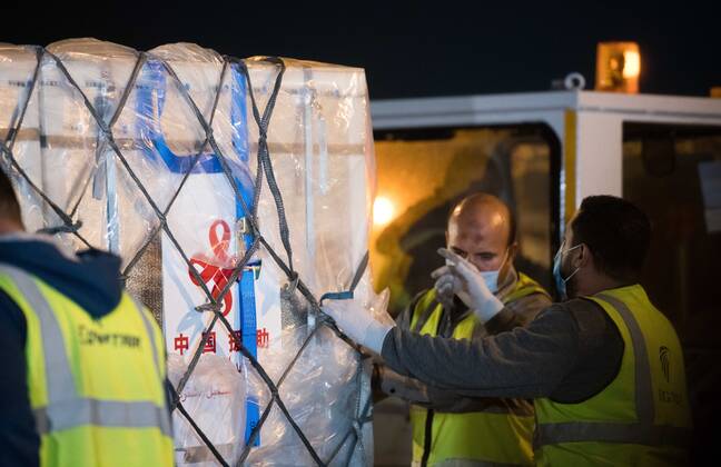 (210223) -- CAIRO, Feb. 23, 2021 -- Workers transport a batch of China s Sinopharm COVID-19 vaccines in Cairo International Airport, Egypt, Feb. 23, 2021. The shipment of COVID-19 vaccines from Chinese company Sinopharm arrived in Egyptian capital Cairo on Tuesday. ) EGYPT-CAIRO-CHINA-VACCINE-ARRIVAL WuxHuiwo 