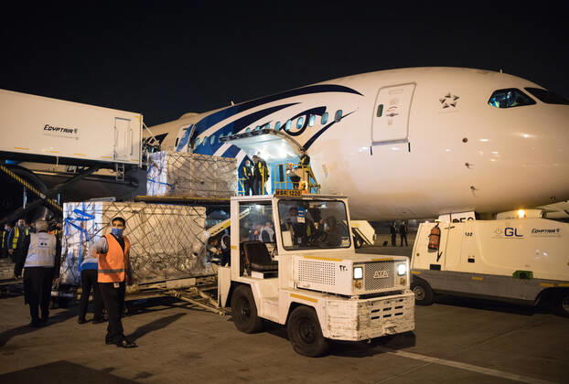 (210223) -- CAIRO, Feb. 23, 2021 -- Workers upload a batch of China s Sinopharm COVID-19 vaccines onto a truck in Cairo International Airport, Egypt, Feb. 23, 2021. The shipment of COVID-19 vaccines from Chinese company Sinopharm arrived in Egyptian capital Cairo on Tuesday. ) EGYPT-CAIRO-CHINA-VACCINE-ARRIVAL WuxHuiwo