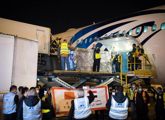 (210223) -- CAIRO, Feb. 23, 2021 -- Workers upload a batch of China s Sinopharm COVID-19 vaccines onto a truck in Cairo International Airport, Egypt, Feb. 23, 2021. The shipment of COVID-19 vaccines from Chinese company Sinopharm arrived in Egyptian capital Cairo on Tuesday. ) EGYPT-CAIRO-CHINA-VACCINE-ARRIVAL WuxHuiwo
