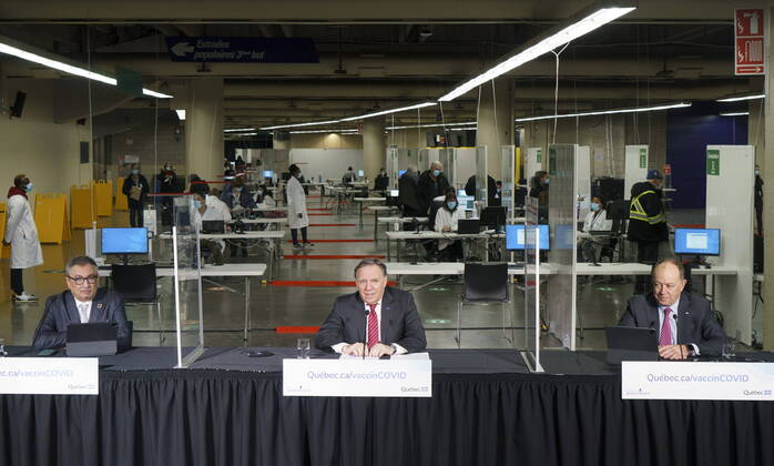 February 23, 2021, Montreal, PQ, Canada: Quebec Premier Francois Legault, Health Minister Christian Dube, right, and Dr. Horacio Arruda, Quebec s director of public health, hold a new conference in a COVID-19 vaccination clinic in Montreal s Olympic Stadium on Tuesday, February 23, 2021. Montreal Canada - ZUMAc35_ 20210223_zaf_c35_041 Copyright: xPaulxChiassonx