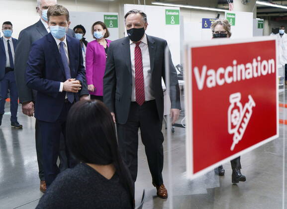 February 23, 2021, Montreal, PQ, Canada: Quebec Premier Francois Legault chats with a woman who just got her COVID-19 vaccine at a clinic in Montreal s Olympic Stadium on Tuesday, February 23, 2021. Montreal Canada  - ZUMAc35_ 20210223_zaf_c35_043 Copyright: xPaulxChiassonx