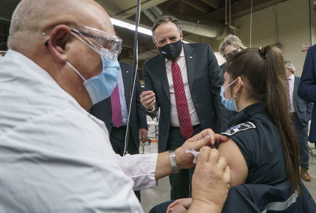 February 23, 2021, Montreal, PQ, Canada: Quebec Premier Francois Legault watches a woman get her COVID-19 vaccine at a clinic in Montreal s Olympic Stadium on Tuesday, February 23, 2021. Montreal Canada  - ZUMAc35_ 20210223_zaf_c35_046 Copyright: xPaulxChiassonx