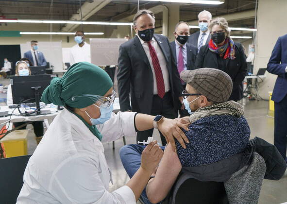 February 23, 2021, Montreal, PQ, Canada: Quebec Premier Francois Legault watches a man get his COVID-19 vaccine at a clinic in Montreal s Olympic Stadium on Tuesday, February 23, 2021. Montreal Canada  - ZUMAc35_ 20210223_zaf_c35_047 Copyright: xPaulxChiassonx