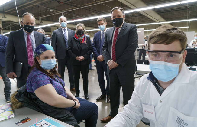 February 23, 2021, Montreal, PQ, Canada: Quebec Premier Francois Legault and Health Minister Christian Dube watch a woman register for her COVID-19 vaccine at a clinic in Montreal s Olympic Stadium on Tuesday, February 23, 2021. Montreal Canada  - ZUMAc35_ 20210223_zaf_c35_048 Copyright: xPaulxChiassonx