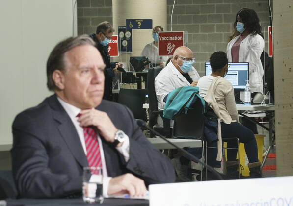February 23, 2021, Montreal, PQ, Canada: Quebec Premier Francois Legault listens to a question during a new conference in a COVID-19 vaccination clinic at Montreal s Olympic Stadium on Tuesday, February 23, 2021. Montreal Canada  - ZUMAc35_ 20210223_zaf_c35_051 Copyright: xPaulxChiassonx