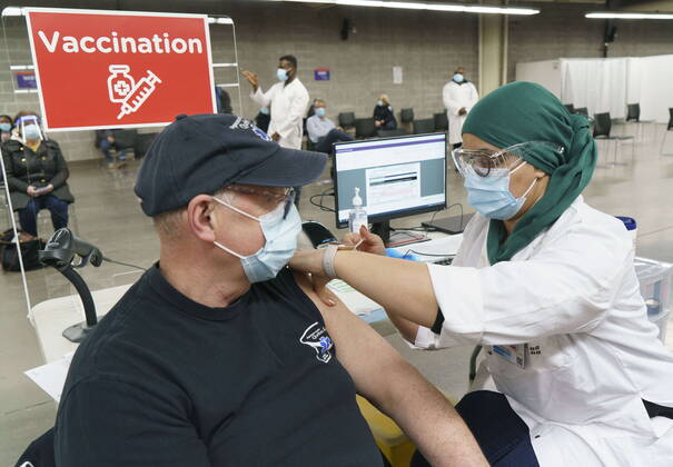 February 23, 2021, Montreal, PQ, Canada: A man receives his COVID-19 vaccine at a vaccination clinic in Montreal s Olympic Stadium on Tuesday, February 23, 2021. Montreal Canada  - ZUMAc35_ 20210223_zaf_c35_054 Copyright: xPaulxChiassonx