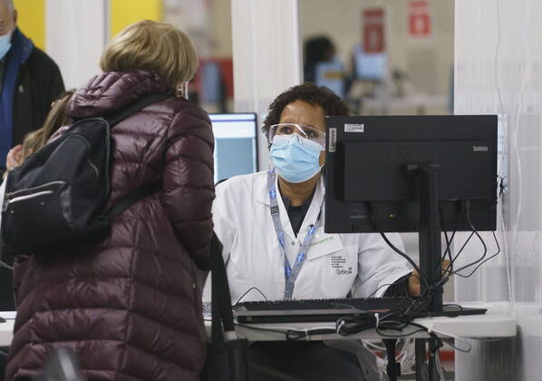 February 23, 2021, Montreal, PQ, Canada: A patient is registered at a COVID-19 vaccination clinic in Montreal s Olympic Stadium on Tuesday, February 23, 2021. Montreal Canada  - ZUMAc35_ 20210223_zaf_c35_056 Copyright: xPaulxChiassonx