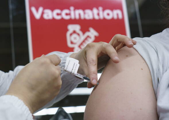 February 23, 2021, Montreal, PQ, Canada: A woman receives her COVID-19 vaccine at a vaccination clinic in Montreal s Olympic Stadium on Tuesday, February 23, 2021. Montreal Canada  - ZUMAc35_ 20210223_zaf_c35_063 Copyright: xPaulxChiassonx