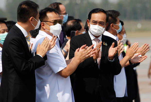 February 24, 2021, Bangkok, Thailand: (FROM L-R) Charge d Affaires of China embassy of Thailand, Thailand s Public Health Minister Anutin Charnvirakul and Thailand s Prime Minister Prayuth Chan-ocha applaud during a ceremony to mark the arrival of 200,000 doses of the Sinovac vaccine shipment at Suvarnabhumi airport in Bangkok. Bangkok Thailand - ZUMAs197 20210224_zaa_s197_013 Copyright: xChaiwatxSubprasomx