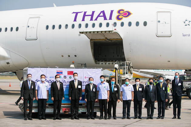 (210224) -- BANGKOK, Feb. 24, 2021 -- Thai Prime Minister Prayut Chan-o-cha (3rd L), Deputy Prime Minister and Public Health Minister Anutin Charnvirakul (2nd L), Chinese Embassy official Yang Xin (4th L) and other guests pose for group photos during a handover ceremony for the first batch of COVID-19 vaccines at Suvarnabhumi Airport in Bangkok, Thailand, Feb. 24, 2021. The first batch of COVID-19 vaccines that Thailand ordered from China s Sinovac Biotech arrived in the capital Bangkok Wednesday, putting the country on track to kickstart its national inoculation program. ) THAILAND-BANGKOK-CHINA-COVID-19-VACCINE-ARRIVAL ZhangxKeren 