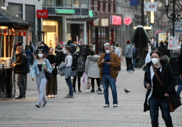 People walk in the street with Safety Mask during the Hard Lockdown of the Covid 19 Coronavirus Pandemie in Nurnberg , Bayern , Deutschland . February 24, 2021.