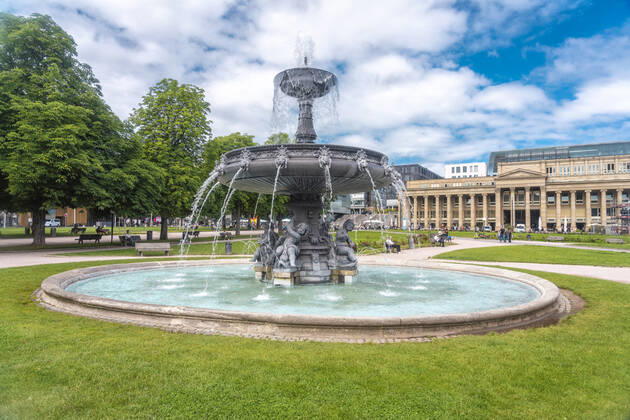 Germany, Baden-Wurttemberg, Stuttgart, Ornate fountain at Schlossplatz square with Konigsbau in background TAMF02830