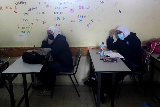 February 27, 2021, Gaza city, Gaza Strip, Palestinian Territory: Palestinian students wearing protective face masks, sit in a classroom, in the morning of the first day of the second semester study, amid the coronavirus disease (COVID-19) outbreak, at their school, in Gaza city, on February 27, 2021 Gaza city Palestinian Territory - ZUMAap3_ 20210227_zaf_ap3_031 Copyright: xMahmoudxAjjourx