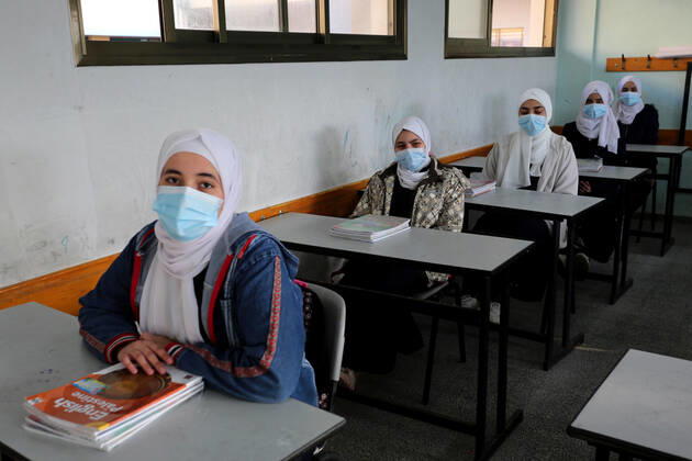 February 27, 2021, Gaza city, Gaza Strip, Palestinian Territory: Palestinian students wearing protective face masks, sit in a classroom, in the morning of the first day of the second semester study, amid the coronavirus disease (COVID-19) outbreak, at their school, in Dair Al Balah in the central of Gaza Strip, on February 27, 2021 Gaza city Palestinian Territory - ZUMAap3_ 20210227_zaf_ap3_088 Copyright: xAshrafxAmrax