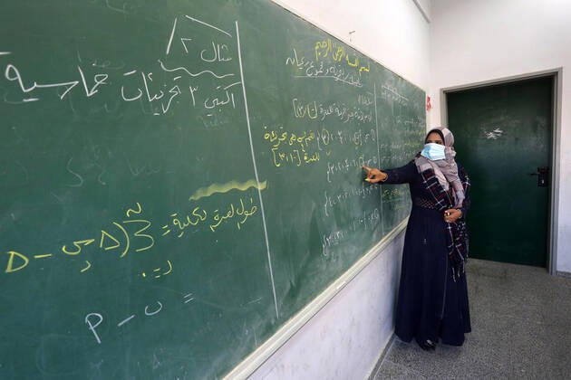 February 27, 2021, Gaza city, Gaza Strip, Palestinian Territory: Palestinian students wearing protective face masks, sit in a classroom, in the morning of the first day of the second semester study, amid the coronavirus disease (COVID-19) outbreak, at their school, in Dair Al Balah in the central of Gaza Strip, on February 27, 2021 Gaza city Palestinian Territory - ZUMAap3_ 20210227_zaf_ap3_090 Copyright: xAshrafxAmrax