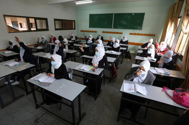 February 27, 2021, Gaza city, Gaza Strip, Palestinian Territory: Palestinian students wearing protective face masks, sit in a classroom, in the morning of the first day of the second semester study, amid the coronavirus disease (COVID-19) outbreak, at their school, in Dair Al Balah in the central of Gaza Strip, on February 27, 2021 Gaza city Palestinian Territory - ZUMAap3_ 20210227_zaf_ap3_112 Copyright: xAshrafxAmrax