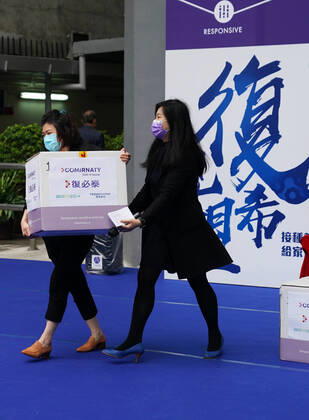 (210227) -- HONG KONG, Feb. 27, 2021 -- Staff members show a freezer which can ensure the vaccines are stored at a temperature of -70 degrees centigrade at a logistics center in Hong Kong, south China, Feb. 27, 2021. A total of 585,000 doses of the Comirnaty COVID-19 vaccine procured by the Hong Kong Special Administrative Region (HKSAR) government arrived in Hong Kong from Germany on Saturday. These were among the first batch of 1 million doses of the Comirnaty vaccine, developed by Fosun Pharma and BioNTech, delivered to Hong Kong. The remaining doses will arrive in early March, a spokesman for the HKSAR government said. The online booking system for this vaccine will open next week. ) CHINA-HONG KONG-COVID-19 VACCINE(CN) LixGang 