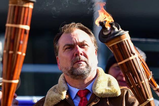 February 27, 2021, Calgary, Alberta, Canada: Preacher Artur Pawlowski lights a tiki torch during the anti-mask protest Freedom March in Calgary, AB on Feb 27, 2021. The march was lead by people carrying tiki torches said to signify the light of the lord but also reminiscent of the Charlottesville Unite the Right rally in 2017. Calgary Canada - ZUMAj113 20210227_zip_j113_008 Copyright: xGavinxJohnx