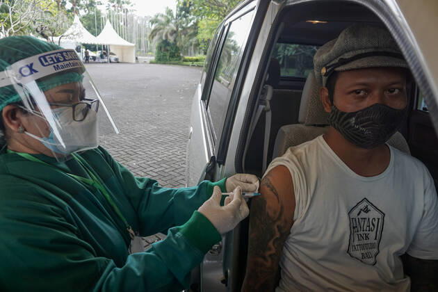 February 28, 2021, Badung, Bali, Indonesia: A healthworker inject a dose of Sinovac Biotech vaccine at drive-thru facilities. Bali to held the second stage of Covid-19 mass vaccination towards tourism workers and online-taxi drivers at Bali Nusa Dua Convention Center (BNDCC), in order to accelerate tourism industry recovery. About 5000 doses of vaccines are targeted to be completed within 1 week. Badung Indonesia - ZUMAb245 20210228_zip_b245_004 Copyright: xDickyxBisinglasix