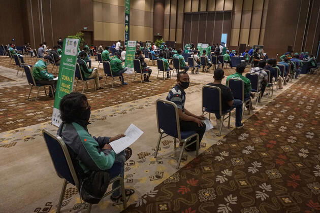 February 28, 2021, Badung, Bali, Indonesia: Hundreds of online taxi drivers and touirsm workers lined up to get their vaccination turn. Bali to held the second stage of Covid-19 mass vaccination towards tourism workers and online-taxi drivers at Bali Nusa Dua Convention Center (BNDCC), in order to accelerate tourism industry recovery. About 5000 doses of vaccines are targeted to be completed within 1 week. Badung Indonesia - ZUMAb245 20210228_zip_b245_009 Copyright: xDickyxBisinglasix