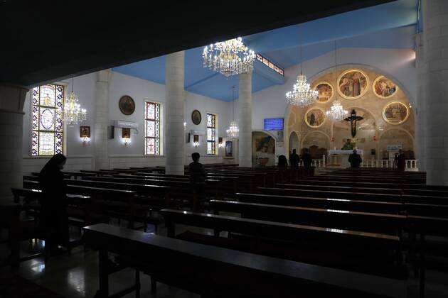 February 28, 2021, Jenin, West Bank, Palestinian Territory: Christian worshippers pray inside Church, amid the coronavirus lockdown in the town of Zababdeh, south of Jenin, in the West Bank on February 28, 2021. Prime Minister Mohammad Shtayyeh announced a new set of restrictions in response to a recent surge in coronavirus infections, including of British and South African mutants, in Palestine.A lockdown of all public and private schools for all classes, except for high school students for a period of 12 days, including kindergartens..A lockdown of all universities, educational and vocational institutes and shifting to distance e-learning programs. A maximum of 50 percent of administrative staff are allowed access to universities..Movemen - ZUMAap3_ 20210228_zaf_ap3_036 Copyright: xOdayxDaibesx