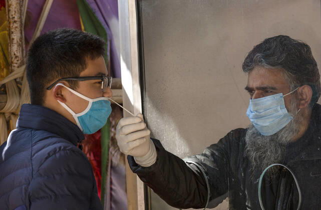 (210228) -- SRINAGAR, Feb. 28, 2021 -- A health worker takes a nasal swab sample from a boy to test with Rapid Antigen Test (RAT) for the COVID-19 in Srinagar city, the summer capital of Indian-controlled Kashmir, Feb. 28, 2021. ) KASHMIR-SRINAGAR-COVID-19 JavedxDar 