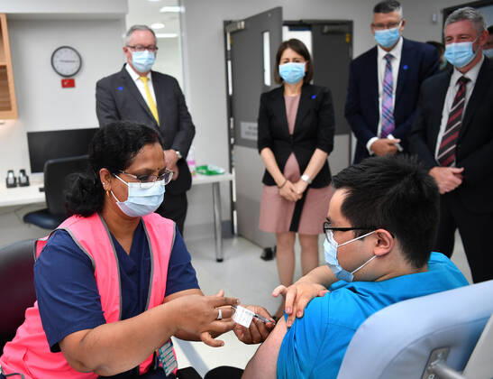 GLADYS BEREJIKLIAN COVID19 VACCINATION HUB TOUR, NSW Premier Gladys Berejiklian and Health Minister Brad Hazzard look on as NSW Health worker Andrew Santoso, a Radiographer in the emergency Department receives his COVID-19 vaccination at the Westmead Hospital Vaccination Hub in Sydney, Monday, March 1, 2021. Phase 1a of the nation-wide vaccination program began last week, with healthcare and border workers the first to be vaccinated. ( NO ARCHIVING, EDITORIAL USE ONLY, NO USE IN BOOKS WITHOUT CONSENT SYDNEY NSW AUSTRALIA  Copyright: xDEANxLEWINSx 20210301001523891079