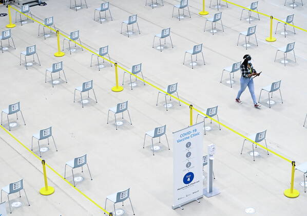 March 1, 2021, Mississauga, on, Canada: A worker walks through the post vaccine waiting area at a mass COVID-19 vaccination clinic for Peel Region during the COVID-19 pandemic in Mississauga, Ont., on Monday, March 1, 2021. Mississauga Canada  - ZUMAc35_ 20210301_zaf_c35_046 Copyright: xNathanxDenettex