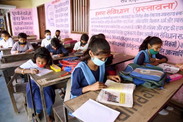 PATNA, INDIA - MARCH 1: Students attending classes at Kanya Madhya Vidyalaya, Adalat Ganj after schools re-opened for the primary section on March 1, 2021 in Patna, India. Nearly a year after the Centre imposed a nationwide lockdown due to the COVID-19 outbreak, several states and UTs have decided to reopen schools and colleges from March 1. As the deadly virus cases are now steadily dropping, the offline classes are going to resume in states such as Bihar, Meghalaya, Jammu and Kashmir, Haryana, among others.(Photo by Santosh Kumar Hindustan Times) Primary Schools Reopen For The First Time Since Lockdown Due To Covid-19