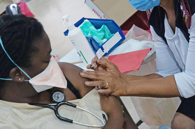 (210303) -- JOHANNESBURG, March 3, 2021 -- A health worker receives COVID-19 vaccine in Charlottle Maxeke Academic Hospital in Johannesburg, South Africa, March 2, 2021. As COVID-19 cases decline, South African cabinet eased lockdown restrictions from alert level three to level one, allowing political and religious gatherings, President Cyril Ramaphosa said on Sunday night. (Photo by Xinhua) SOUTH AFRICA-JOHANNESBURG-COVID-19-VACCINATION MatthewxMartinxBrink 